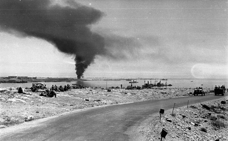 Fall of Tobruk June 21, 1942. Smoke rising from the Port in the background.